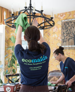Two Maids Performing House Cleaning Services on a Dinning Room Table and Chandelier in Federal Way