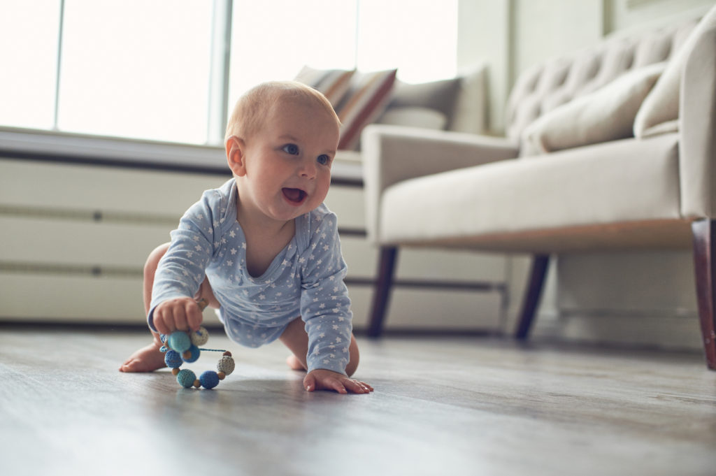 Baby crawling on a newly cleaned floor by ecomaids house cleaning services in Green Bay.
