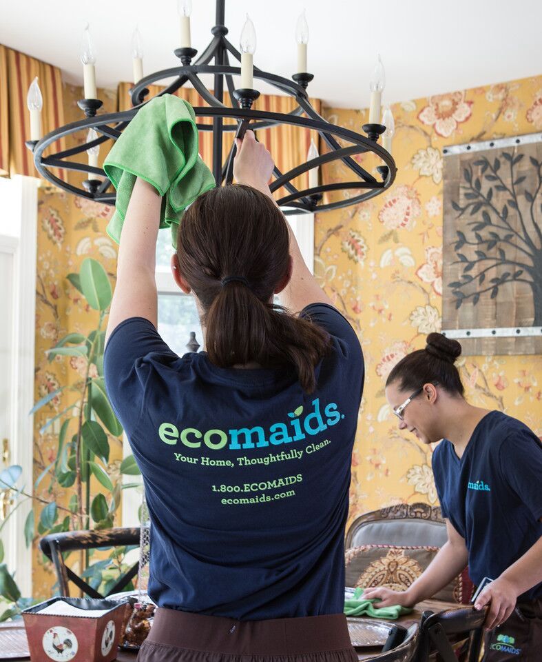 Two Maids Performing House Cleaning Services on a Dinning Room Table and Chandelier in Lake Oswego.