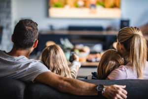 Family enjoying a movie after recieving ecomaids apartment cleaning service in the woodlands